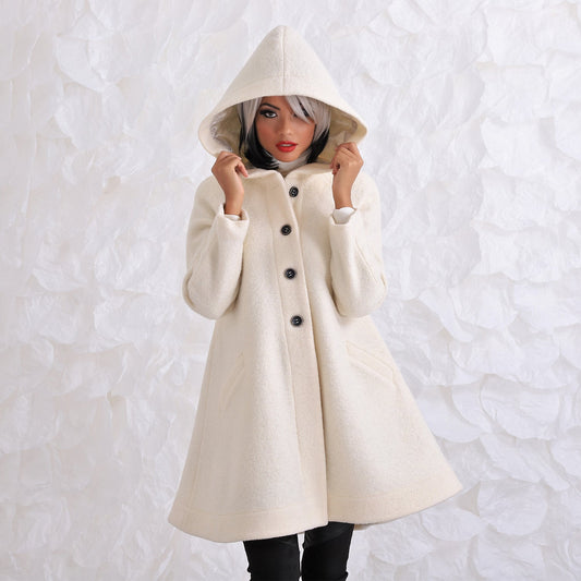 woman in white wool hooded coat with black buttons in A shape